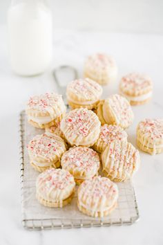 cookies on a cooling rack next to a bottle of milk