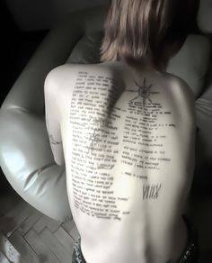 the back of a man's body with writing on it