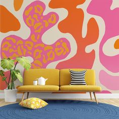 a living room with a couch, rug and painting on the wall in bright colors