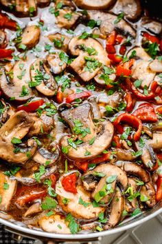 a pan filled with cooked mushrooms and peppers