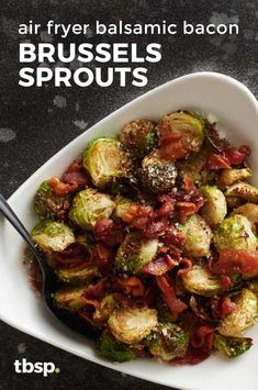 a white bowl filled with brussel sprouts and bacon on top of a table