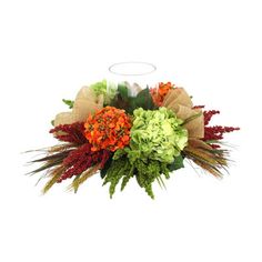 a vase filled with flowers and greenery on top of a table