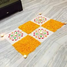 the floor is decorated with yellow flowers and candles for diwaling or decorating