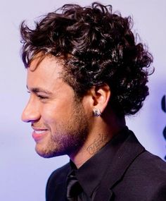 a close up of a person wearing a suit and tie with tattoos on his neck