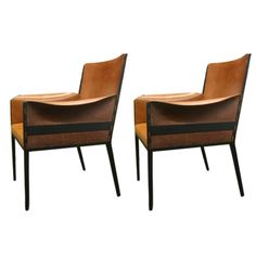 two brown chairs sitting next to each other