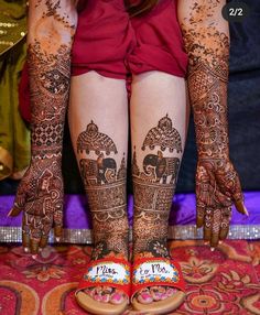 the legs and feet of a woman with henna tattoos