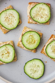 cucumber sandwiches are arranged on a plate