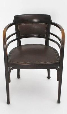 a wooden chair with leather upholstered on the back and arm rests against a white background