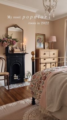 a bed room with a neatly made bed next to a fire place and a chandelier