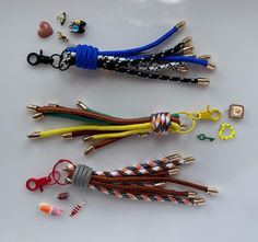 four pairs of lanyards are shown on a white surface with scissors and other accessories