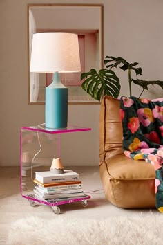 a living room filled with furniture and a lamp on top of a table next to a chair