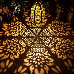 the shadow of a stained glass window is cast on the floor in front of it