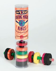 an assortment of colored wooden toys in a tube