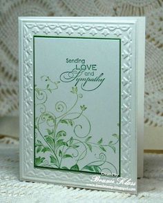 a white card with green flowers on it and the words sending love and sympathy written in cursive writing