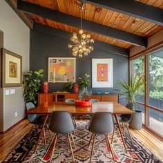 a dining room table with chairs and a rug on the floor in front of it