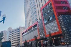 a city street with tall buildings in the background