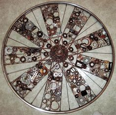 a metal wheel with lots of assorted parts on it