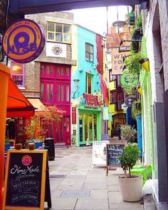 an alleyway with many colorful buildings and signs