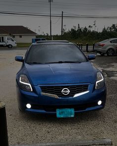 a blue car parked in a parking lot