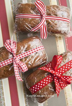 three loafs of bread wrapped in plastic wrap and tied with red polka dot ribbon