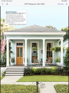 a blue house with white trim and columns