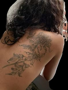 the back of a woman with tattoos on her body