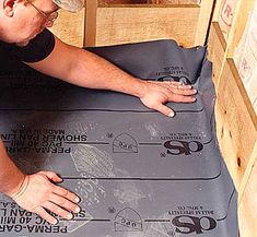 a man working on an area rug in his home