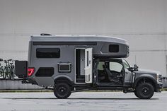 an rv parked in front of a building