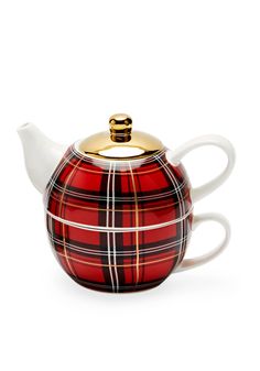 a red and black plaid teapot with gold trimmings on the top, sitting in front of a white background