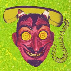 an image of a creepy mask with horns on it's head and yellow eyes