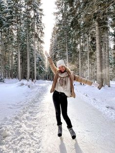 a woman riding skis down a snow covered road