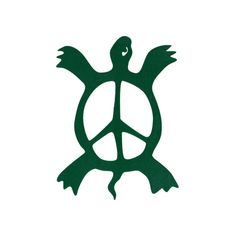 a green peace sign sitting on top of a white wall next to a black bird