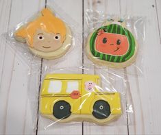 three decorated cookies sitting on top of plastic bags