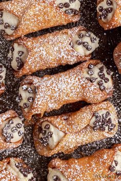 several pastries covered in powdered sugar and chocolate