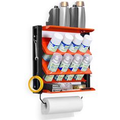 an orange shelf with several bottles and scissors on it next to a roll of toilet paper