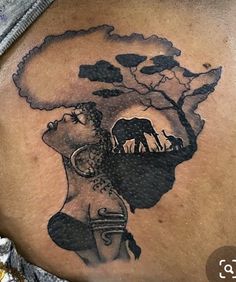 a woman's stomach with an elephant and giraffe tattoo on her belly