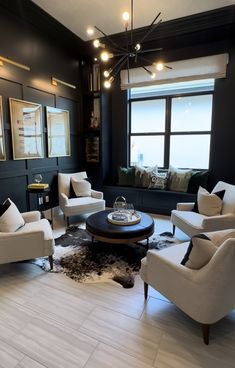 a living room with black walls and white furniture