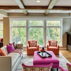 a living room filled with furniture and a flat screen tv mounted to the wall above it