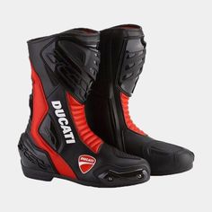 a pair of black and red motorcycle boots with the word ducati on the side