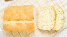 two loaves of bread sitting on top of a white and yellow checkered towel