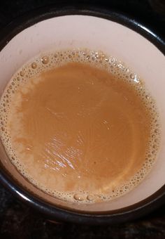 a cup filled with liquid sitting on top of a table