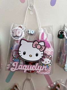 there is a hello kitty bag hanging on the wall next to some cookies and candies