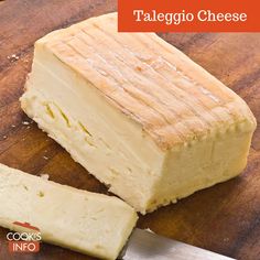 a piece of cheese on a cutting board with a knife