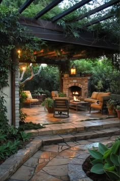 an outdoor fireplace and seating area in a backyard