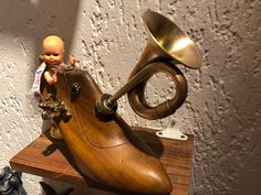 a toy trumpet sitting on top of a wooden table next to other toys and figurines