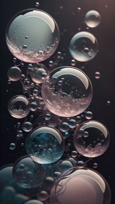 many bubbles are floating in the air on a black surface with water droplets around them