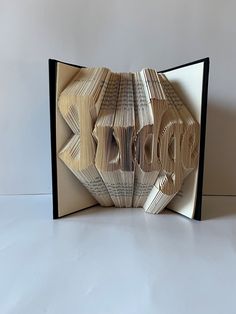 an open book with the word hope cut out of it's pages and folded in half