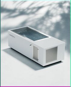 a white box with water inside sitting on top of a table