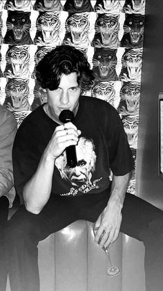 black and white photograph of a man sitting on a chair