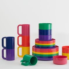 colorful stacking cups and mugs are stacked on top of each other in different colors